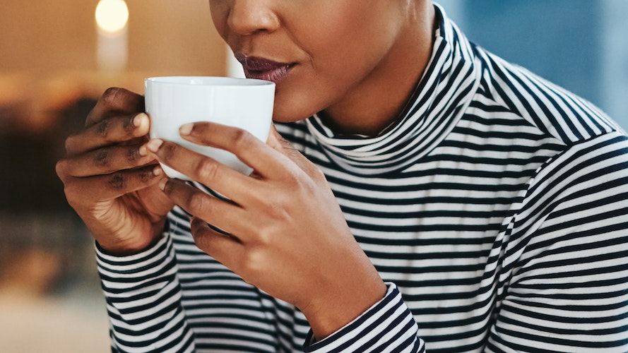 woman drinking coffee does coffee cause acne